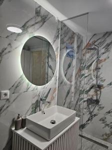 a bathroom with a sink and a mirror at MVM rooms 5 in Nydri
