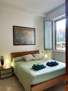a bedroom with a bed with two towels on it at Your home in Milan - Elegant & Comfortable Stay in Crescenzago