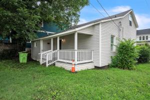 a small white house with a white porch at Quiet Family Home - Downtown, Pet Friendly, 4 Beds in Raleigh +24 photos