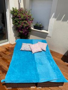 a blue table with two pillows on top of it at La maison du Bonheur 34 in Florensac +31 photos