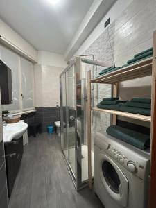 a bathroom with a washing machine and a sink at Your home in Milan - Elegant & Comfortable Stay in Crescenzago