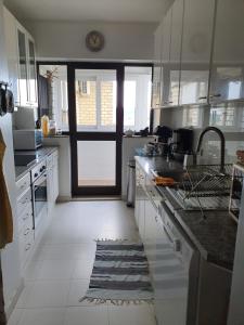 a kitchen with a sink and a door to a kitchen at BEST OF NATURE 1, Matosinhos beach, Porto city parc, METRO in Matosinhos