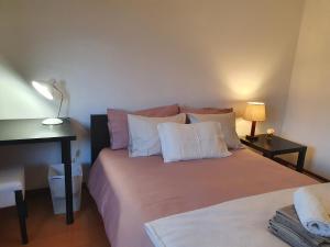 a bedroom with a bed with white and pink pillows at BEST OF NATURE 1, Matosinhos beach, Porto city parc, METRO in Matosinhos +9 photos