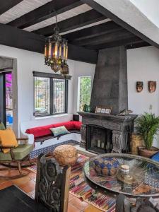 a living room with a table and a fireplace at Experience Guanajuato's Magic from Casa Mirador! in Guanajuato