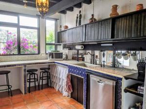 a kitchen with a counter and some stools in it at Experience Guanajuato's Magic from Casa Mirador! in Guanajuato