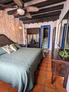 a bedroom with a bed and a ceiling fan at Experience Guanajuato's Magic from Casa Mirador! in Guanajuato