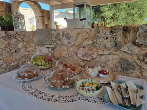 a table with many plates of food on it at Trulli Di Spinaruta in Grottaglie
