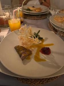 a white plate with food on a table at Dar Rihana Dadès in Aït Idaïr