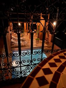 a view of a balcony with a table and a fence at Dar Rihana Dadès in Aït Idaïr