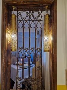 a mirror with a gate with a table in a room at Dar Rihana Dadès in Aït Idaïr