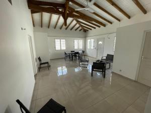 a large room with chairs and tables in it at Bethanie in Le Gosier