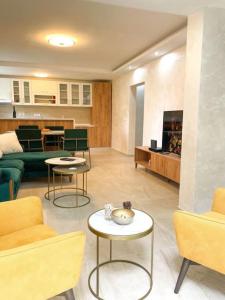 a living room with a couch and a table and chairs at Tihanas apartment in Kotor