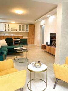 a living room with a couch and tables and chairs at Tihanas apartment in Kotor +8 photos