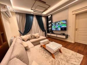 a living room with a couch and a tv at villa Yasser Ezzat in Cairo