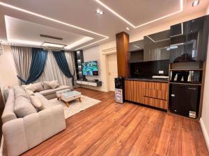 a living room with a couch and a flat screen tv at villa Yasser Ezzat in Cairo
