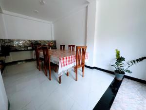 a dining room with a table and chairs at Shrine Inn in Kandy