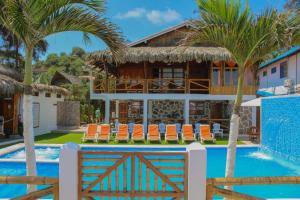 a villa with a swimming pool and a resort at HANGA ROA HOTEL in Montañita