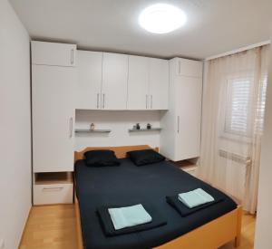a bedroom with a large bed with white cabinets at Vila Maria in Vir