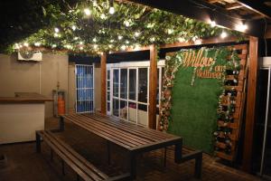 a bench in front of a wine cellar with lights at Willow On Wellfreer in Durban
