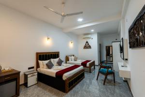 a hotel room with two beds and a tv at Golden stars hotel Dambulla in Dambulla