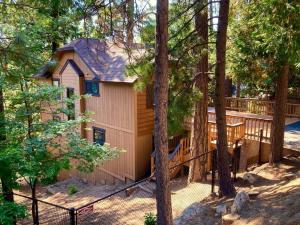 a small house in the woods with a deck at Cozy 3BR Dog-Friendly Cabin- Level 2 EV Chgr in Lake Arrowhead +31 photos