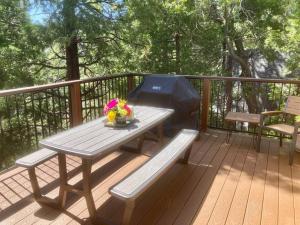 a picnic table and a grill on a deck at Cozy 3BR Dog-Friendly Cabin- Level 2 EV Chgr in Lake Arrowhead