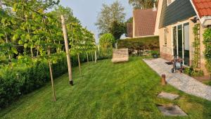 a yard with a row of trees next to a house at Ferienhaus Sonnenschein in Sint Maarten
