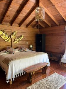 a bedroom with a bed in a wooden room at Zidada Hotel and Chalets in Bernal
