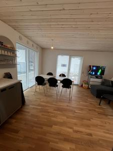 a living room with a table and chairs at Vacationhouse in Klakvik in Klaksvík