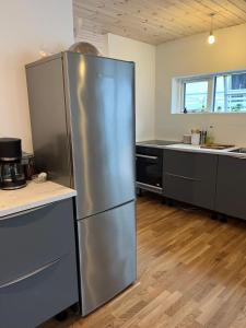 a kitchen with a large stainless steel refrigerator at Vacationhouse in Klakvik in Klaksvík