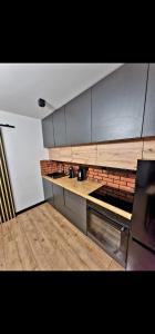 a kitchen with wooden counters and stainless steel appliances at Apartament z Balią in Świeradów-Zdrój