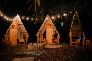 a couple of wooden huts with lights on them at Socialtel Atitlan in Panajachel