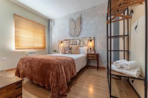 a bedroom with a large bed and a ladder at Hogar de ZOE in Trujillanos +15 photos