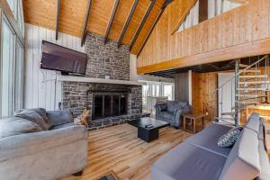 a living room with a couch and a fireplace at Mountain View 148 - 4 chambres - 13 personnes in Beaupré