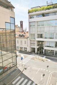 an empty street in a city with tall buildings at Casa MadArt City Centre MXP TrainStation in Gallarate