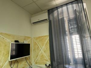 a living room with a television and a window at Apartman Perper in Trebinje