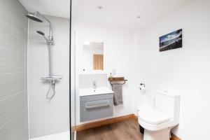 a bathroom with a toilet and a sink and a shower at Well-located countryside cottage in Nailsea
