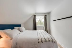 a bedroom with a white bed and a window at La Pionnière - 5 chambres - 13 personnes in Saint-Férréol-les-Neiges +11 photos