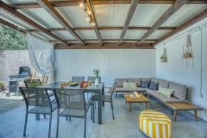 a patio with a table and chairs and a couch at Apartman Ivan in Posedarje