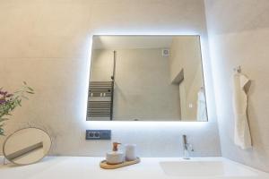 a bathroom with a mirror over a sink at Apartman Ivan in Posedarje +22 photos