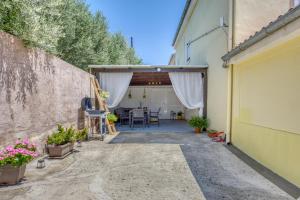 a garage with a table and some plants in pots at Apartman Ivan in Posedarje