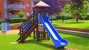 a playground with a blue slide in a park at Cappuccini Appartments in Peschiera del Garda