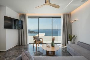 a living room with a couch and a table at Astelia Residence in Kókkinon Khoríon