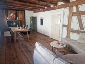 a living room with a couch and a table at Historic cozy flat in Citycenter by Lake Constance in Überlingen +16 photos