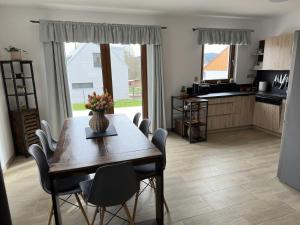 a kitchen and dining room with a table and chairs at Chata Horák in Frymburk