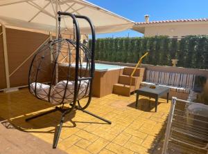 a swing in a yard with an umbrella at Hotel Kourkoumelata in Argostoli