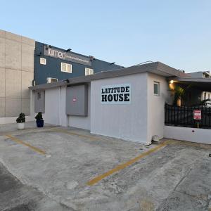 a building with a sign that reads furniture house at Latitude Adjustment in San Juan