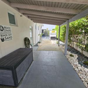 a wooden bench sitting on the side of a building at Latitude Adjustment in San Juan