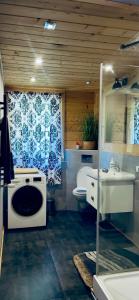 a bathroom with a sink and a washing machine at Apartament u Teresy in Harkabuz +43 photos