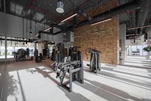 a gym with several treadmills and ellipticals at Kabene Exotic, Burj Khalifa & Fountain View, 5 Starts, 4 Bedroom, Best In Dubai in Dubai